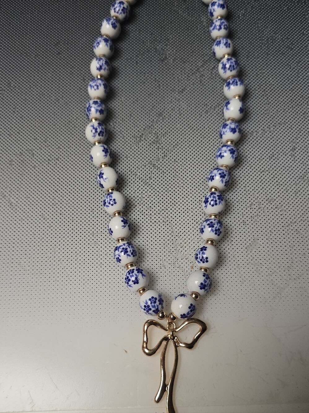 Porcelain Blue Floral Beads Feminine Necklace with Dressy Gold Bow Pendant